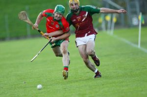 Killyon's Calvin Ryan and Anthony Forde Kiltale strain every muscle to reach the ball during the Meath senior hurling championship final at Pairc Tailteann